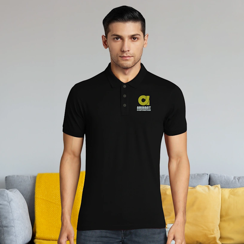 Man wearing a black polo shirt with a logo in a casual setting