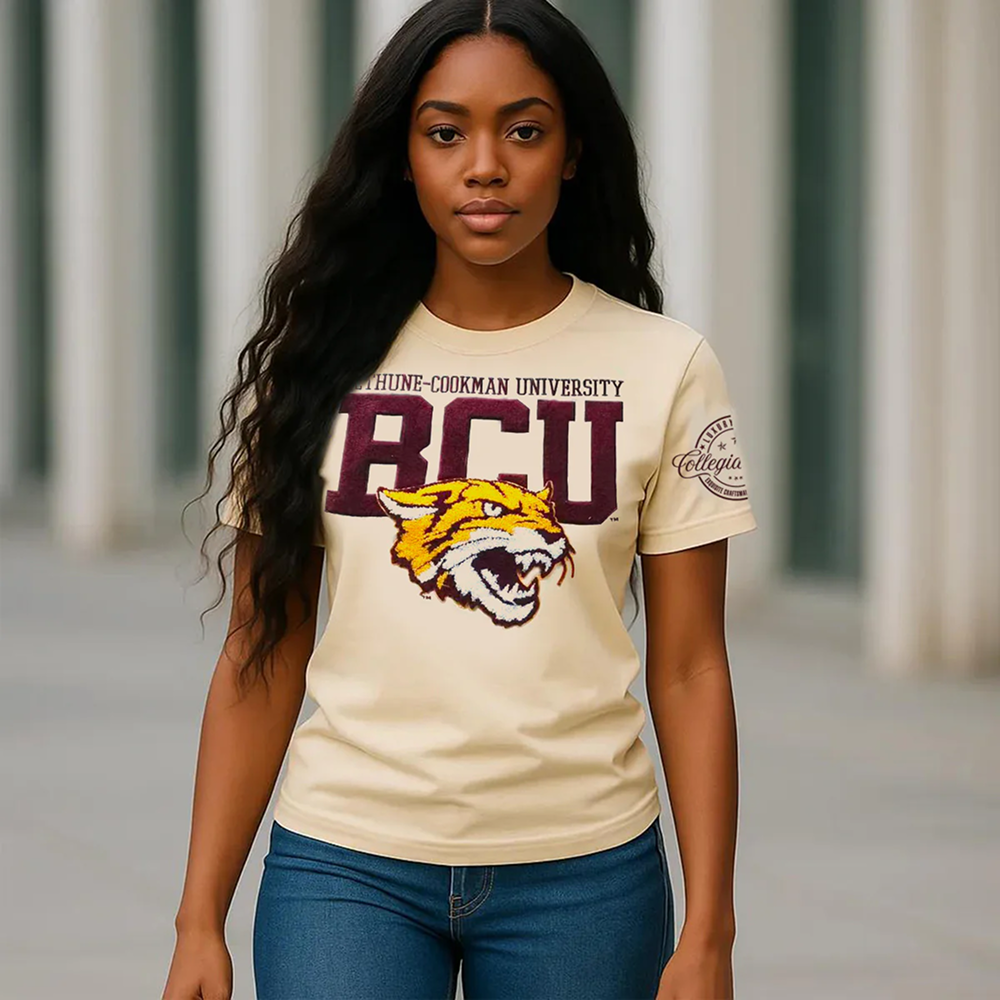 Woman wearing a beige t-shirt with RCU and a tiger logo, standing in front of classical columns.