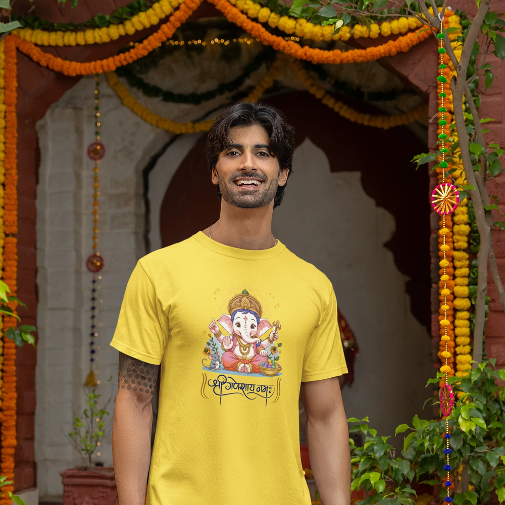 Man wearing a yellow t-shirt with a colorful graphic design in front of a decorated entrance.