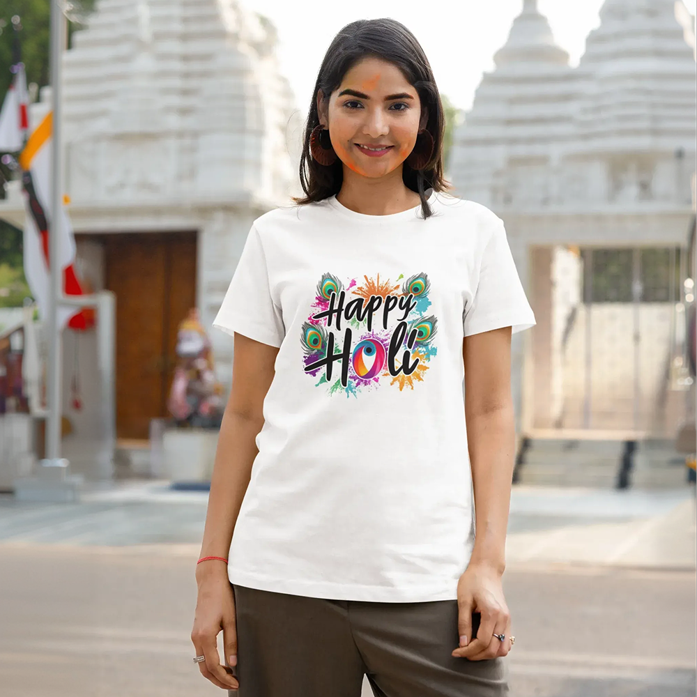 Woman wearing a 'Happy Holi' t-shirt in front of a temple.