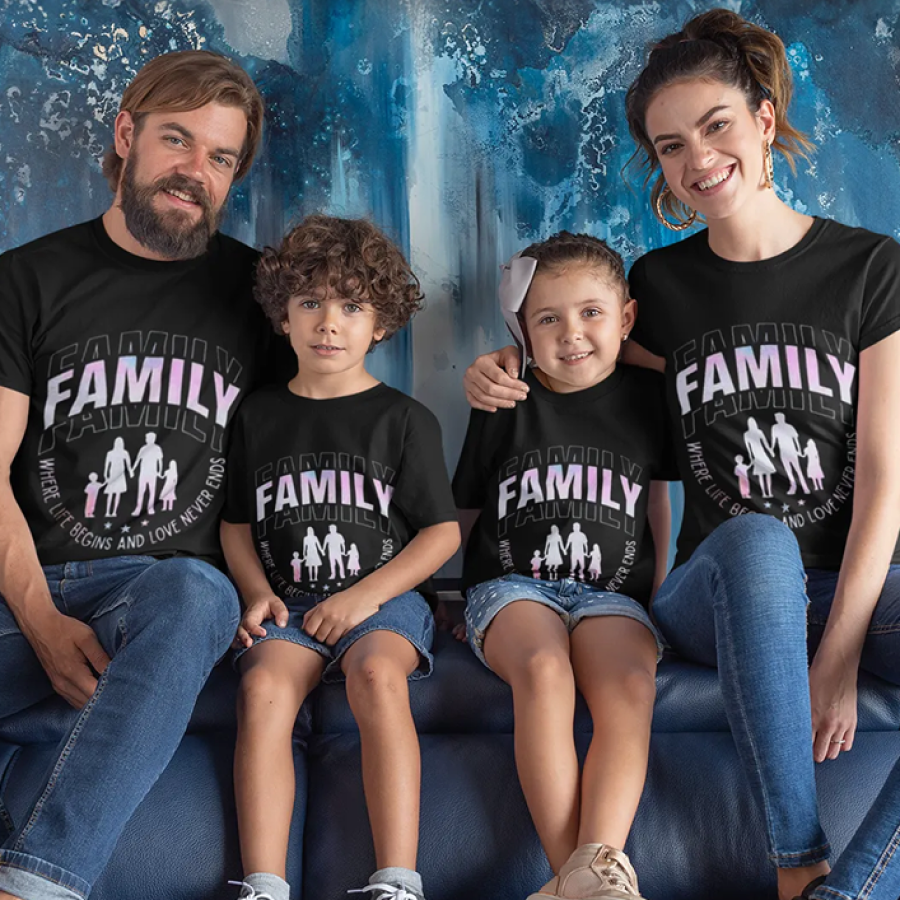 Family of four wearing matching black t-shirts with 'FAMILY' printed on them, sitting together against a blue textured wall.