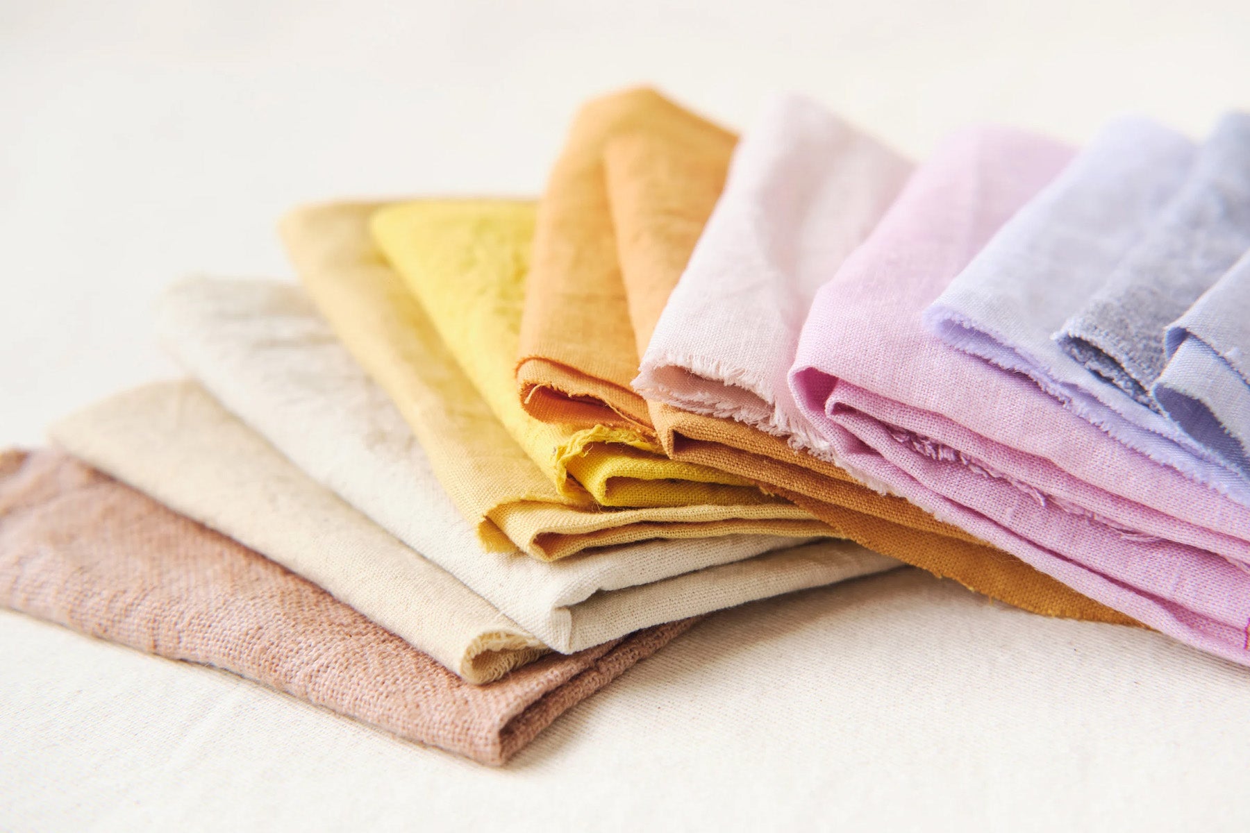 Stack of folded colorful fabric on a white background